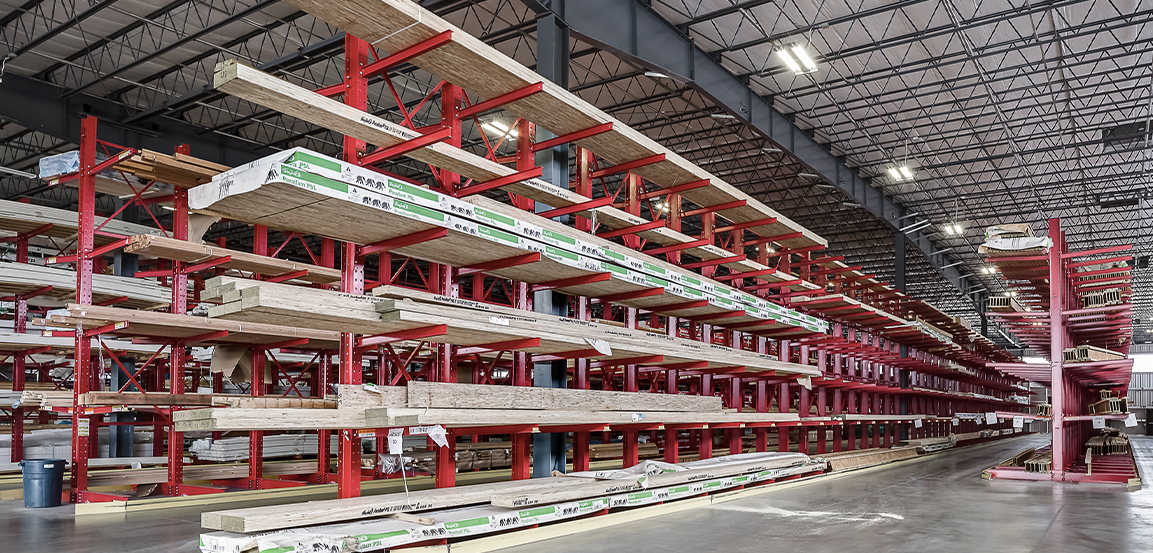 Butler building with lumber on large shelves.